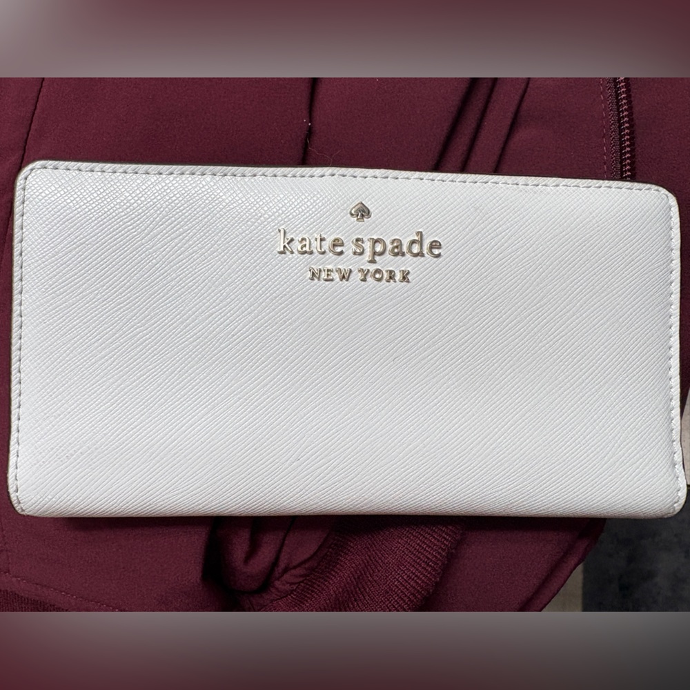 kate spade cream trifold wallet with gold logo